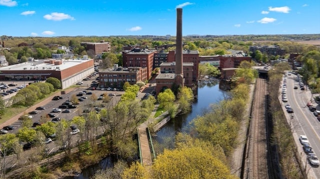 aerial view of property and surrounding area with a nearby body of water