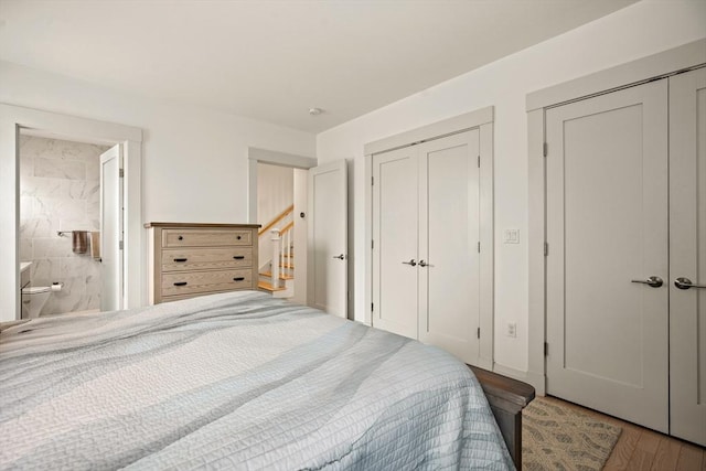 266 Merrimac St Unit F, Newburyport, MA 01950 - bedroom featuring two closets, wood finished floors, and ensuite bath