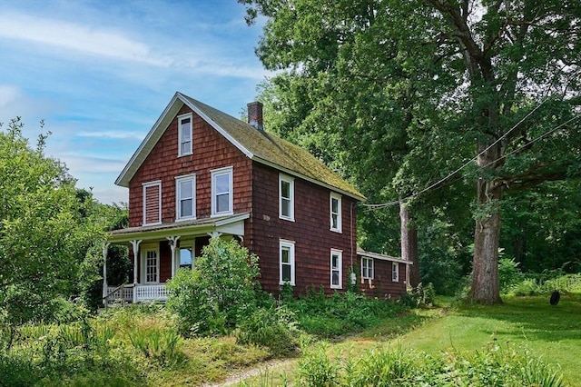 115 S Shelburne Rd, Greenfield, MA 01301 - view of side of property with a chimney, covered porch, and roof with shingles