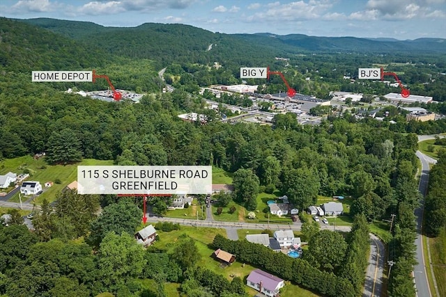 115 S Shelburne Rd, Greenfield, MA 01301 - aerial overview of property's location with a heavily wooded area and mountains