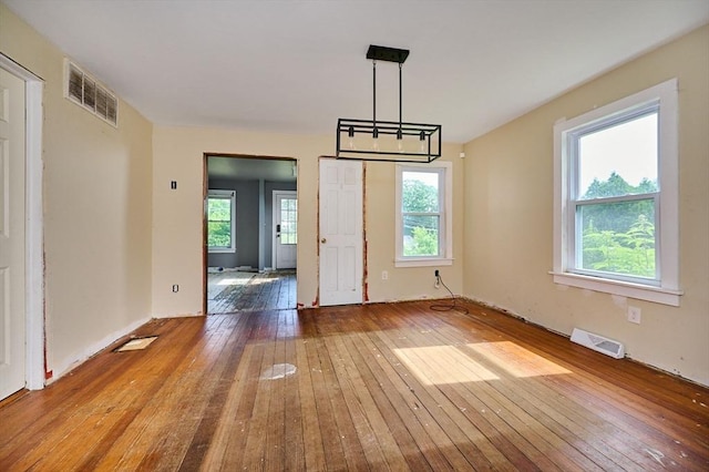 115 S Shelburne Rd, Greenfield, MA 01301 - unfurnished dining area with wood-type flooring and a chandelier