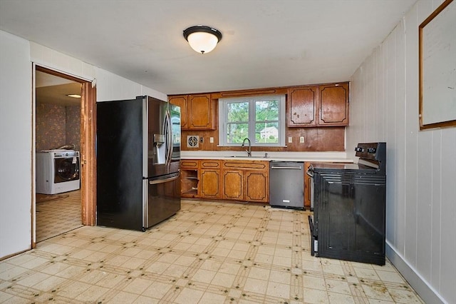 115 S Shelburne Rd, Greenfield, MA 01301 - kitchen featuring appliances with stainless steel finishes, washer / clothes dryer, light flooring, light countertops, and brown cabinets