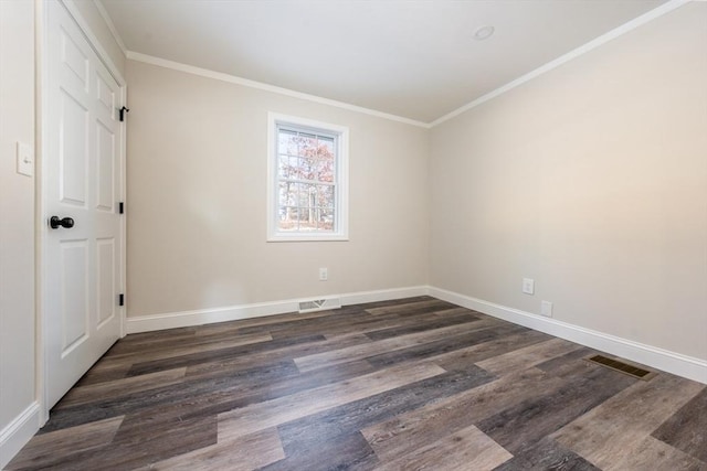 empty room featuring dark hardwood / wood-style flooring and crown molding