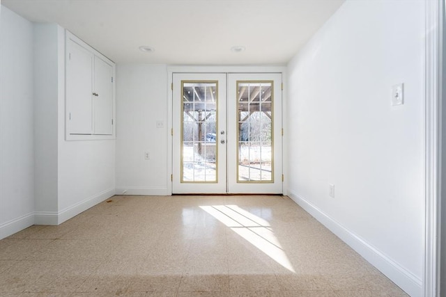 spare room featuring french doors