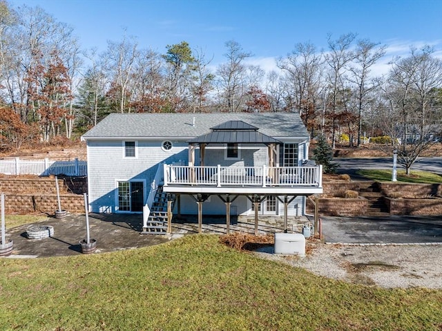 back of house featuring a gazebo, a deck, and a lawn