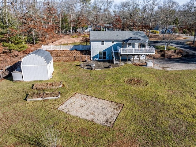 exterior space with a yard, a shed, and a deck