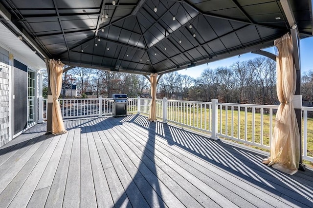 wooden terrace featuring a gazebo