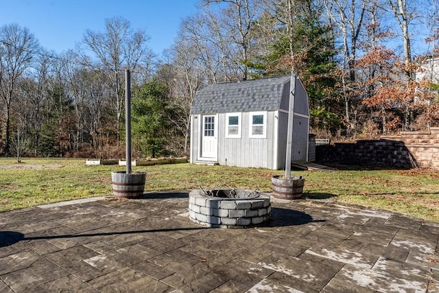 view of outbuilding featuring a yard and an outdoor fire pit