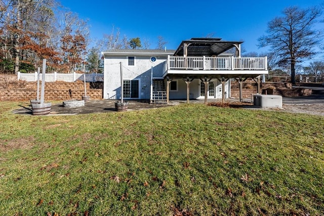 rear view of property with a patio, a deck, and a lawn