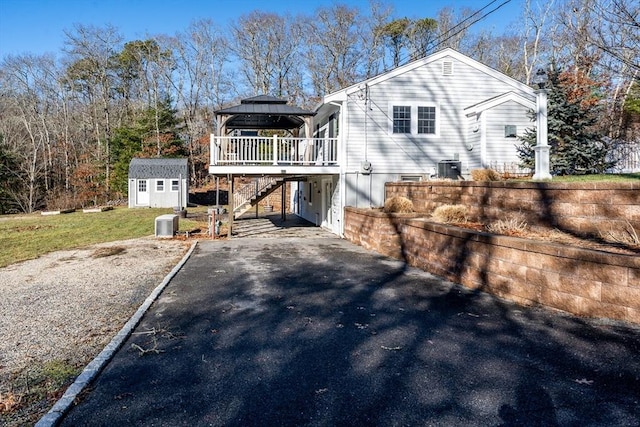 exterior space with a gazebo, a deck, and a storage shed