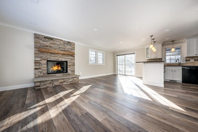 unfurnished living room featuring a fireplace, dark hardwood / wood-style floors, and ornamental molding