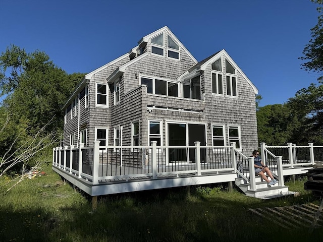 rear view of property with a wooden deck