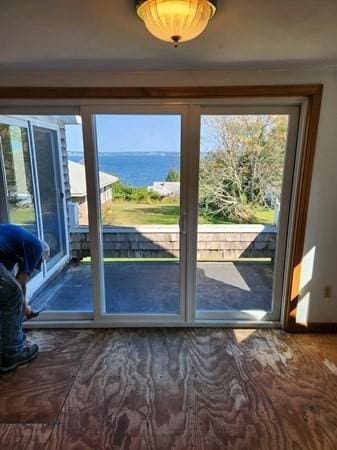 doorway to outside featuring a water view