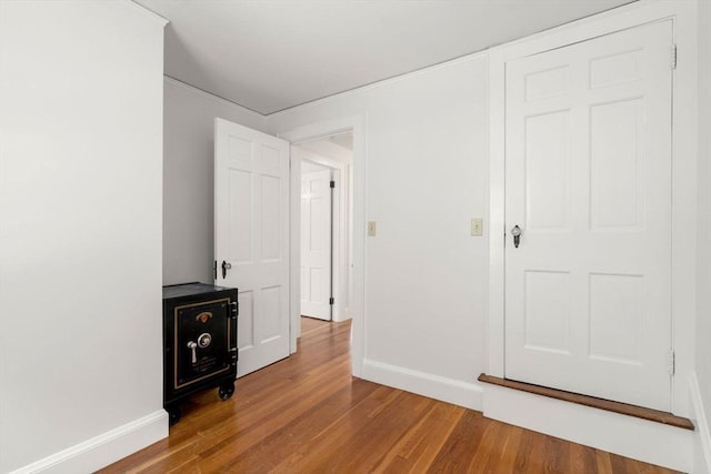 spare room with wood finished floors and baseboards