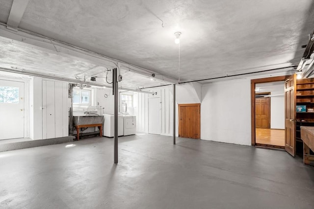 below grade area with washing machine and clothes dryer