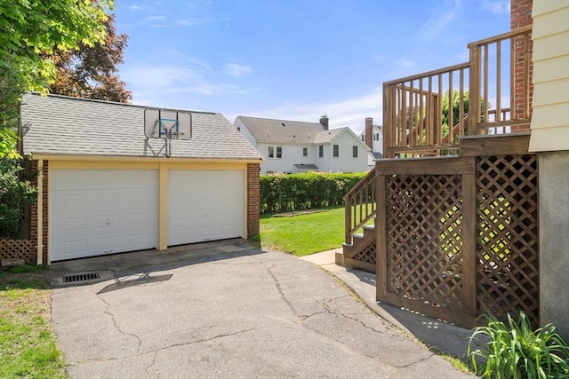 gate with an outbuilding, stairs, a wooden deck, and a lawn