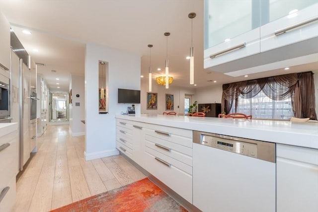 kitchen with oven, light wood-style flooring, white cabinets, light countertops, and dishwasher