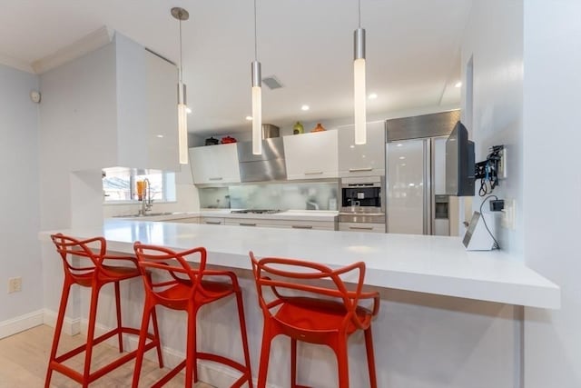 kitchen featuring oven, a peninsula, white cabinets, gas stovetop, and modern cabinets