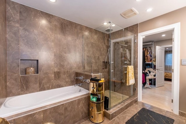 full bath featuring visible vents, a tile shower, recessed lighting, tile walls, and tiled tub