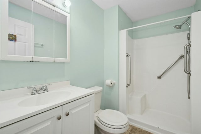 full bath featuring a shower, vanity, and toilet