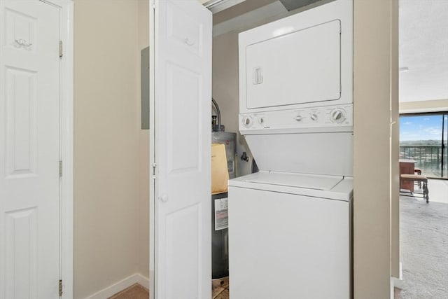 laundry area with stacked washer and dryer, laundry area, and baseboards