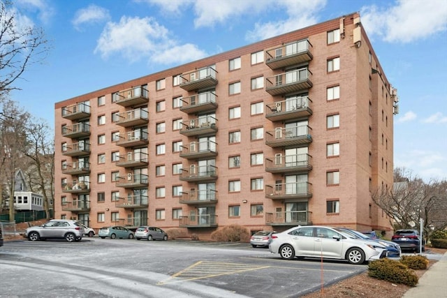 view of building exterior with uncovered parking