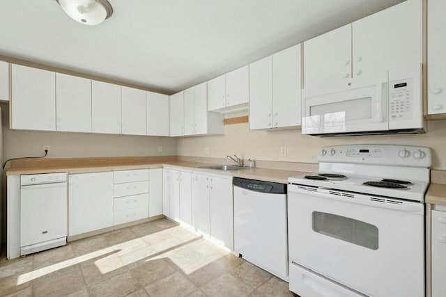 kitchen with light countertops, white appliances, a sink, and white cabinets