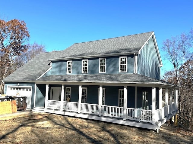 country-style home with a garage and a porch