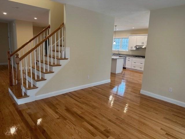 interior space with sink and hardwood / wood-style floors