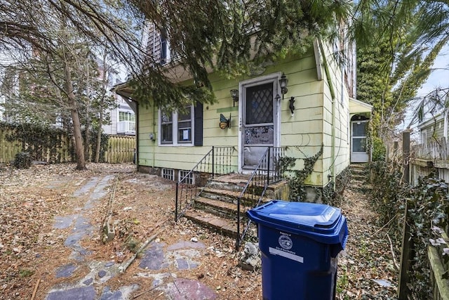 bungalow-style house with fence