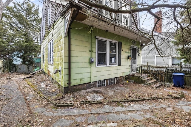 view of side of home featuring fence