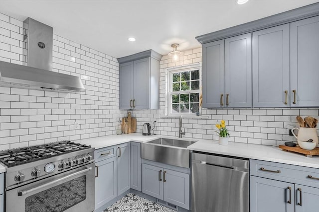 5 Vandergrift St, Lawrence, MA 01843 - kitchen with appliances with stainless steel finishes, wall chimney exhaust hood, backsplash, light countertops, and gray cabinets