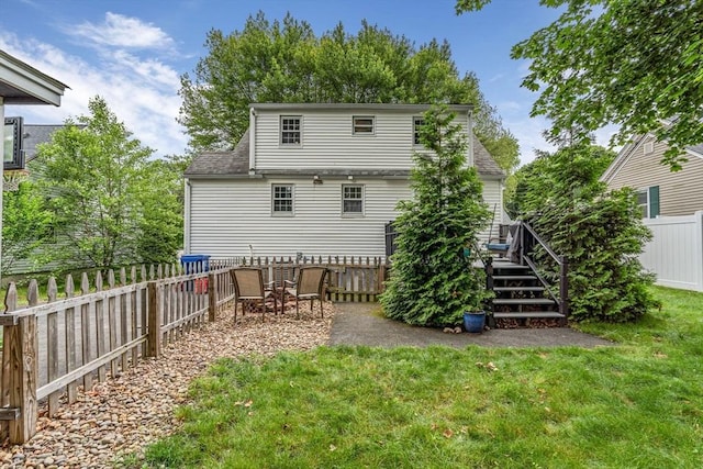5 Vandergrift St, Lawrence, MA 01843 - back of house with a fenced backyard, a deck, and roof with shingles