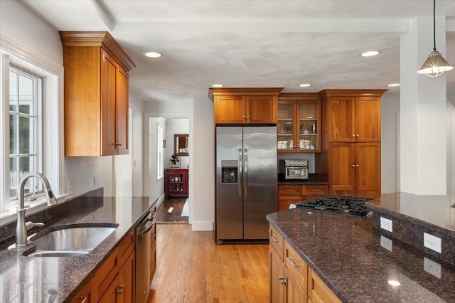 76 Union St, Natick, MA 01760 - kitchen featuring brown cabinets, recessed lighting, appliances with stainless steel finishes, and a sink