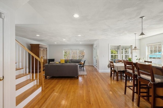 76 Union St, Natick, MA 01760 - living area with baseboards, a healthy amount of sunlight, stairway, and light wood-style floors