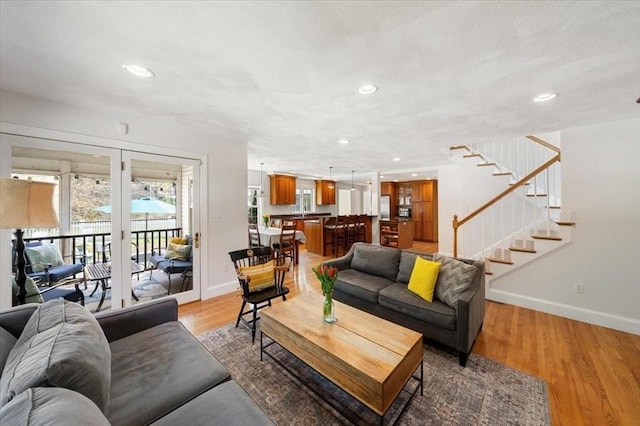76 Union St, Natick, MA 01760 - living room with baseboards, recessed lighting, stairs, and light wood-style floors