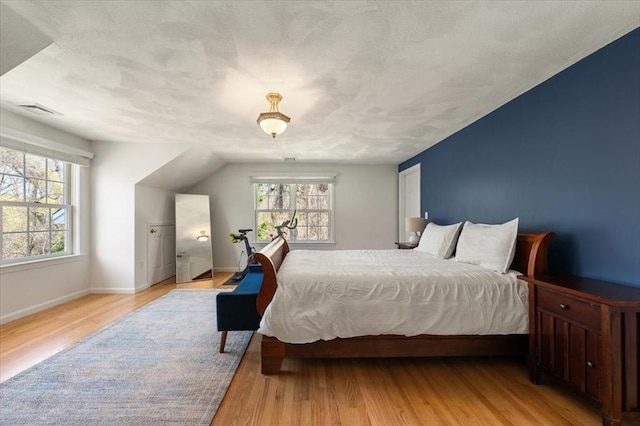 76 Union St, Natick, MA 01760 - bedroom with light wood-style floors, baseboards, and visible vents