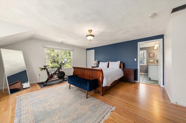 76 Union St, Natick, MA 01760 - bedroom featuring baseboards, lofted ceiling, light wood finished floors, and visible vents