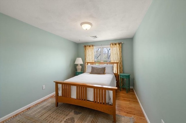 76 Union St, Natick, MA 01760 - bedroom featuring baseboards, wood finished floors, and visible vents