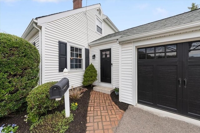 76 Union St, Natick, MA 01760 - view of exterior entry with a chimney and a garage