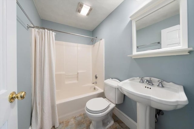 76 Union St, Natick, MA 01760 - bathroom with baseboards, shower / bath combo, toilet, and stone finish flooring