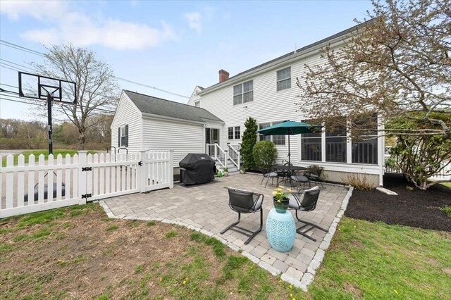 76 Union St, Natick, MA 01760 - rear view of house with fence, a gate, a patio, and a chimney
