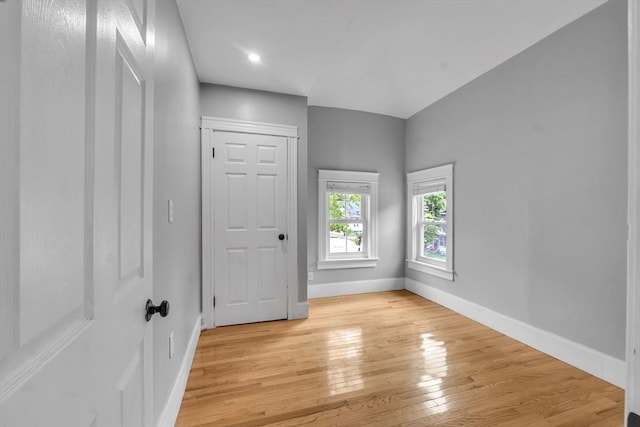 spare room featuring light wood-style flooring, baseboards, and recessed lighting