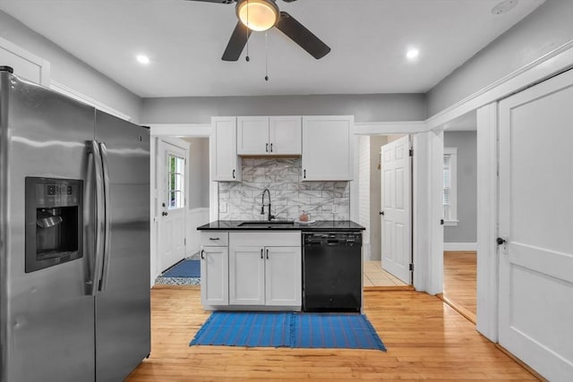 kitchen featuring stainless steel refrigerator with ice dispenser, dishwasher, a sink, dark countertops, and ceiling fan