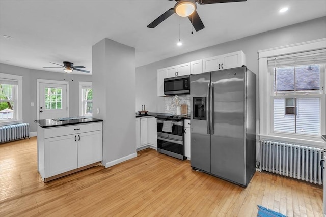 kitchen featuring radiator, stainless steel appliances, ceiling fan, a peninsula, and recessed lighting
