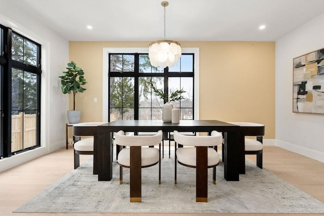 dining space with light hardwood / wood-style flooring and plenty of natural light