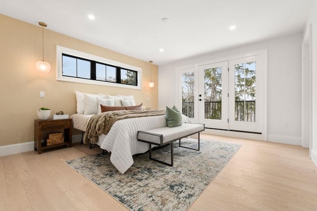 bedroom featuring access to exterior and light wood-type flooring