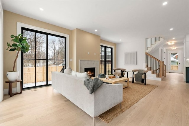 living room with a fireplace and light hardwood / wood-style floors