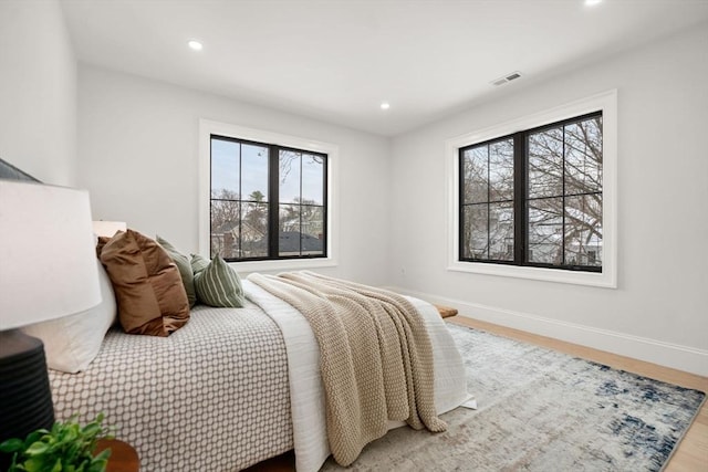 bedroom with hardwood / wood-style flooring