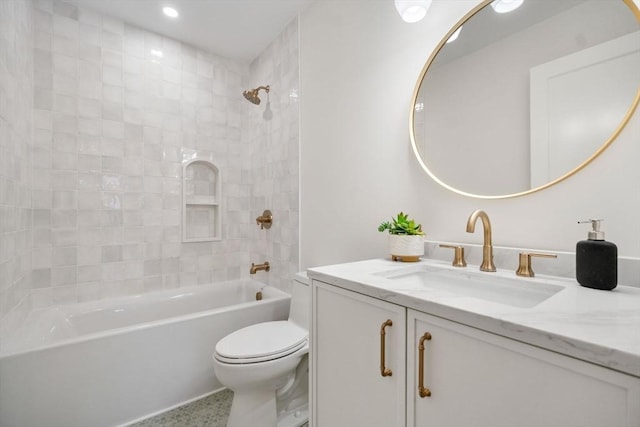 full bathroom featuring vanity, tiled shower / bath combo, and toilet